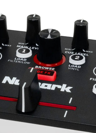 Close-up of a Numark DJ controller with knobs and buttons on a white background