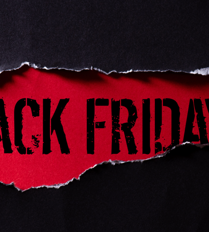 Torn paper revealing 'Black Friday' on a black background