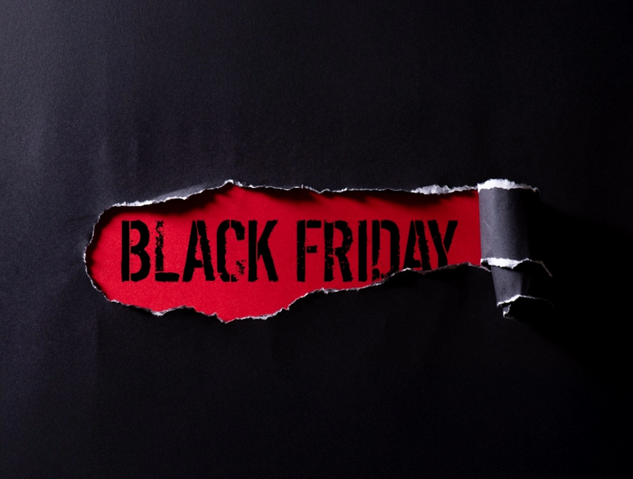 Torn black paper revealing the word 'BLACK FRIDAY' in red.