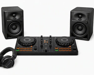 DJ controller bundle featuring a black 4-drum DJ controller in the center, flanked by two matching black studio speakers, with black over-ear headphones in the foreground on a clean white background.