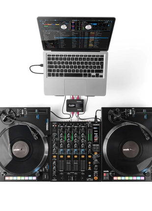 Reloop Flux Go DJ setup with laptop, RP-8000 turntables, and mixer on a white background